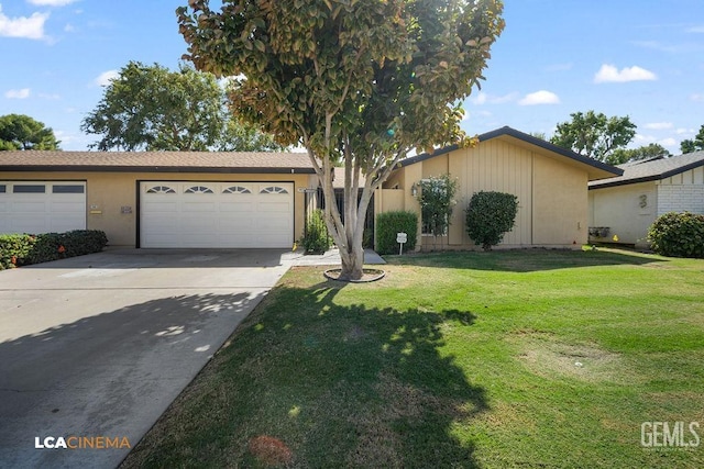 ranch-style house featuring a garage and a front yard