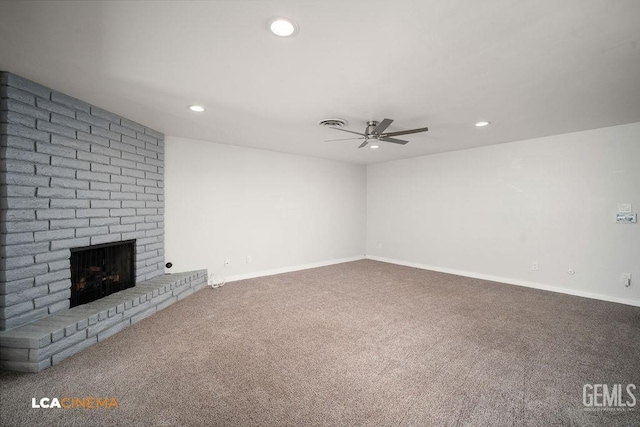 unfurnished living room with ceiling fan, carpet, and a fireplace