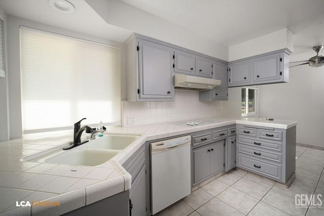 kitchen featuring white appliances, tile counters, kitchen peninsula, ceiling fan, and light tile patterned floors