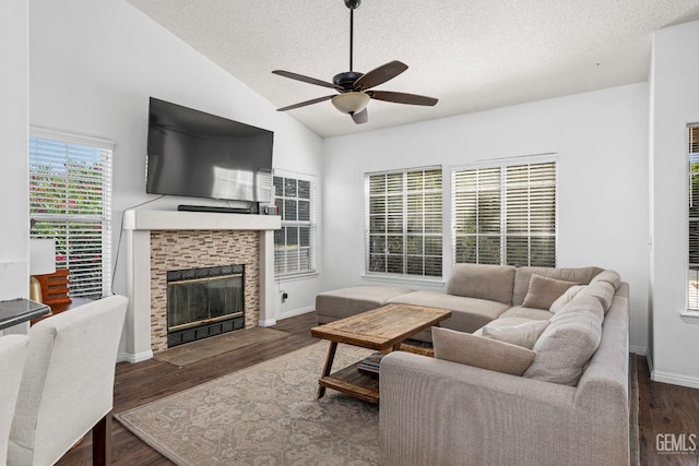 5928 Dyce Way, Bakersfield, CA 93306 - living room with a ceiling fan, a textured ceiling, vaulted ceiling, a tile fireplace, and wood finished floors