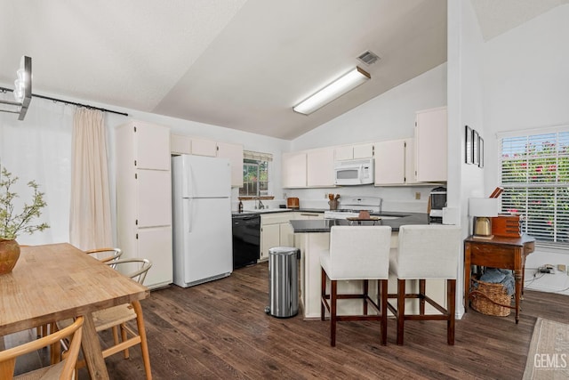 5928 Dyce Way, Bakersfield, CA 93306 - kitchen with white appliances, a peninsula, dark wood finished floors, dark countertops, and white cabinets