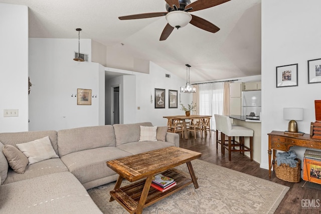 5928 Dyce Way, Bakersfield, CA 93306 - living room with vaulted ceiling, dark wood-style flooring, a ceiling fan, and a chandelier
