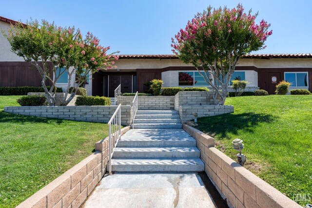 5928 Dyce Way, Bakersfield, CA 93306 - mediterranean / spanish-style house featuring stucco siding, a front lawn, and stairway