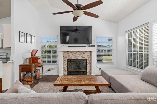 5928 Dyce Way, Bakersfield, CA 93306 - living room featuring vaulted ceiling, wood finished floors, a ceiling fan, and a tiled fireplace