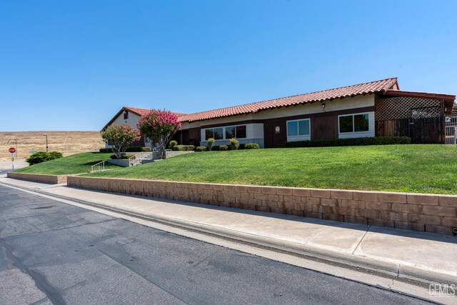 5928 Dyce Way, Bakersfield, CA 93306 - ranch-style house with a tile roof, a front lawn, and stucco siding
