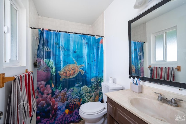 bathroom featuring a shower with curtain, vanity, and toilet