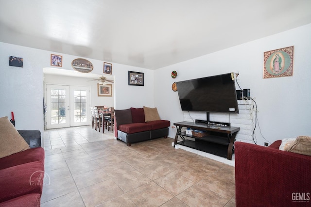 living room with light tile patterned floors, french doors, and ceiling fan