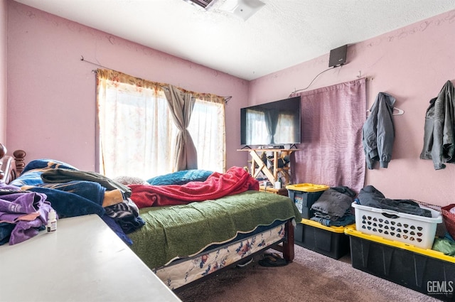 carpeted bedroom featuring a textured ceiling