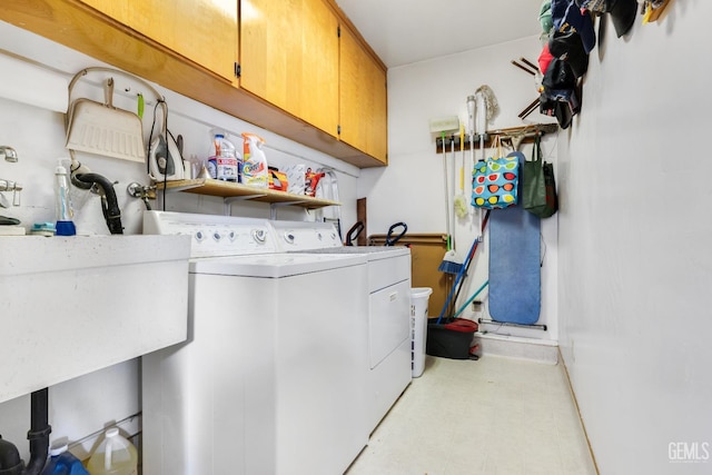 318 Cypress St, Bakersfield, CA 93304 - laundry room with cabinet space, washing machine and clothes dryer, and light floors