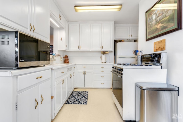 318 Cypress St, Bakersfield, CA 93304 - kitchen with white appliances, white cabinets, and light countertops