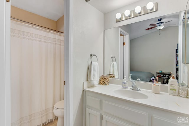 bathroom featuring toilet, ceiling fan, and vanity