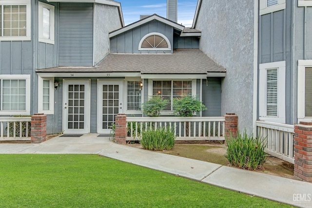 view of exterior entry featuring a yard