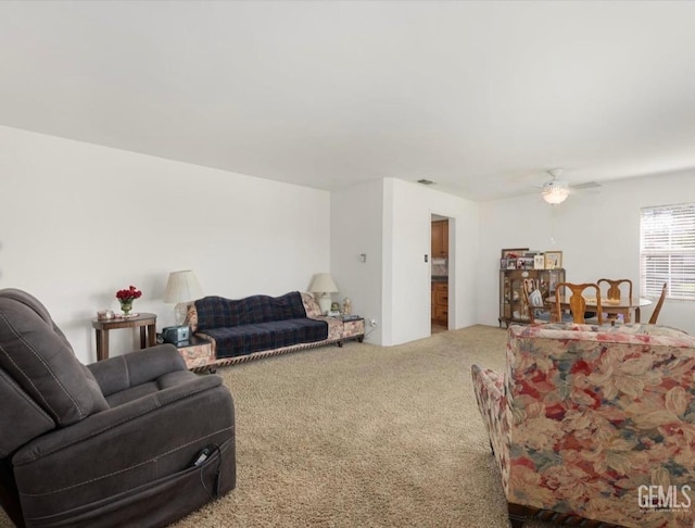 living room featuring carpet flooring and ceiling fan