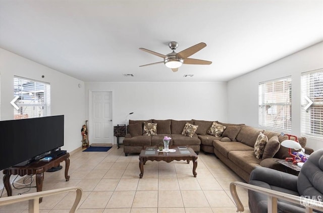 living room with ceiling fan, light tile patterned flooring, and plenty of natural light