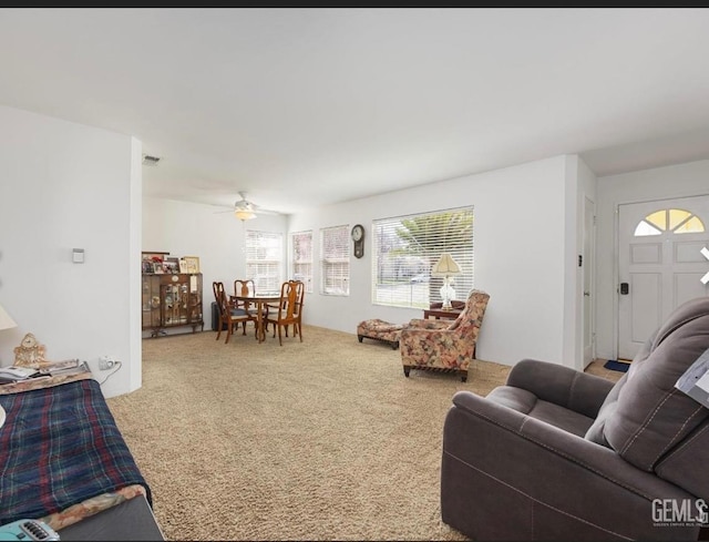 living room featuring carpet floors and ceiling fan