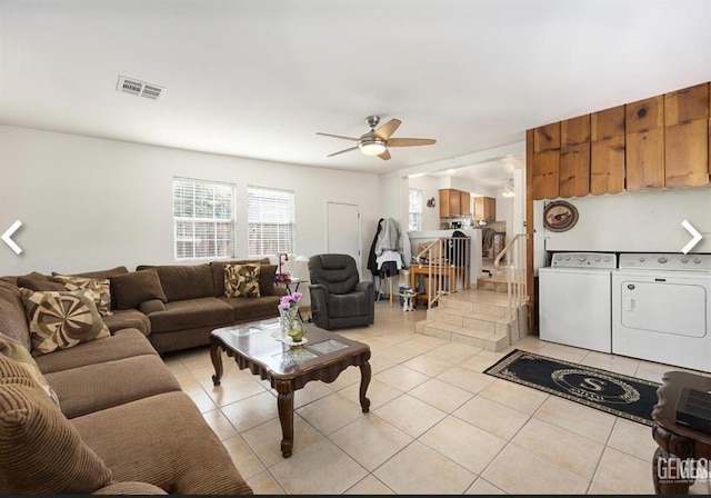 living room featuring ceiling fan, light tile patterned flooring, and separate washer and dryer