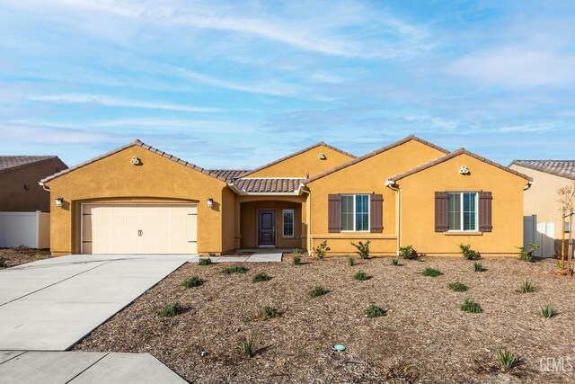 5016 Beaverhead Ave, Bakersfield, CA 93306 - view of front of property with driveway, a garage, a tiled roof, and stucco siding