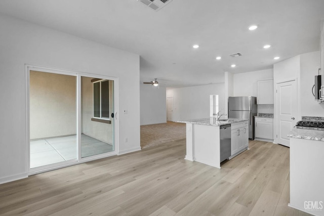 5016 Beaverhead Ave, Bakersfield, CA 93306 - kitchen with appliances with stainless steel finishes, open floor plan, recessed lighting, ceiling fan, and light wood-style flooring