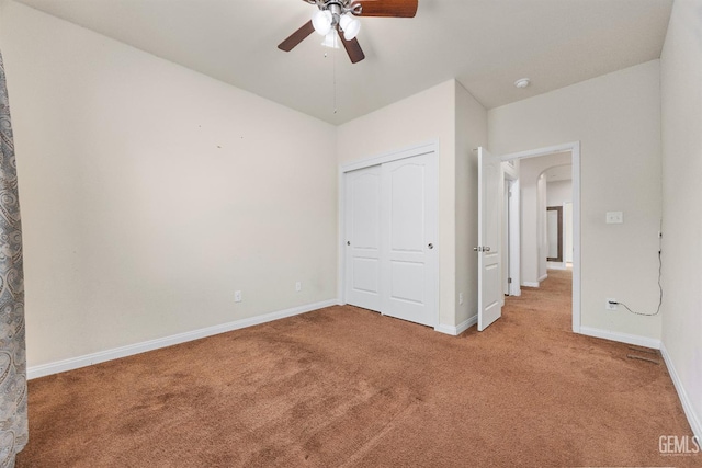 unfurnished bedroom with baseboards, carpet, and a closet