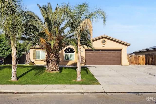 view of front of home featuring a garage, stucco siding, driveway, and a front yard