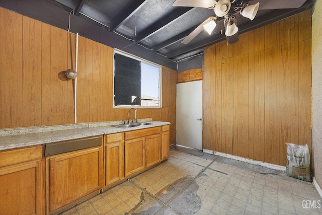 interior space featuring a sink, tile patterned floors, ceiling fan, and wooden walls