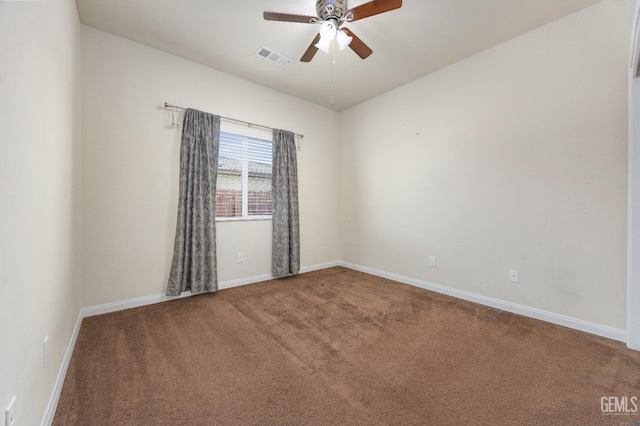 spare room featuring baseboards, ceiling fan, carpet flooring, and visible vents