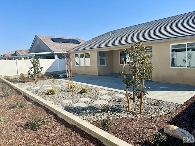 back of property with a patio