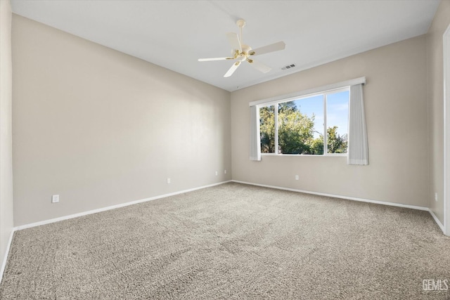 carpeted empty room featuring ceiling fan