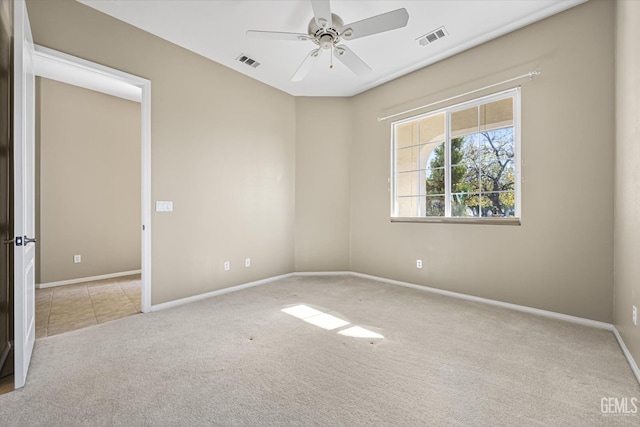 carpeted spare room with ceiling fan