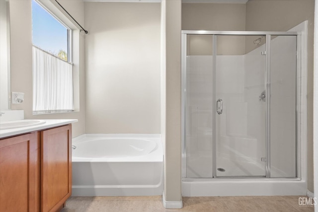 bathroom with separate shower and tub, vanity, tile patterned floors, and a wealth of natural light