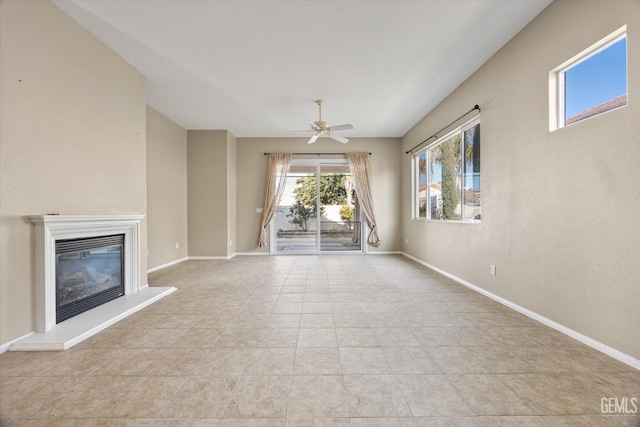 unfurnished living room with ceiling fan and light tile patterned floors