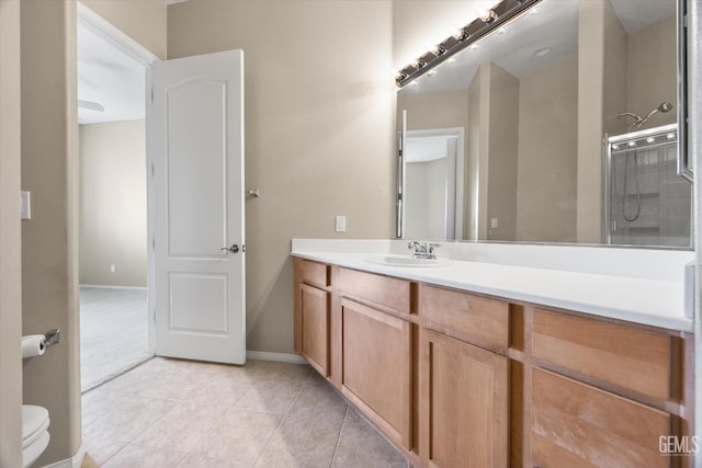 bathroom featuring a shower with shower door, tile patterned floors, and vanity