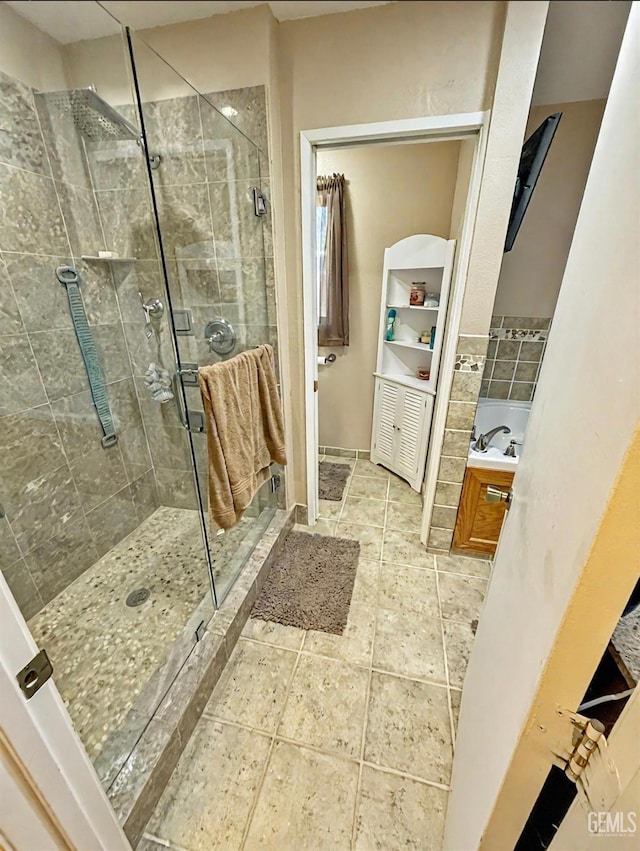 full bath featuring a sink and a stall shower