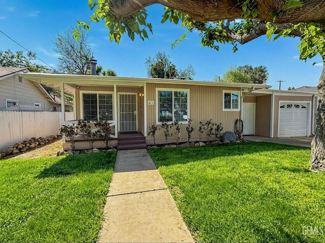 ranch-style home featuring covered porch, fence, a front yard, and a garage