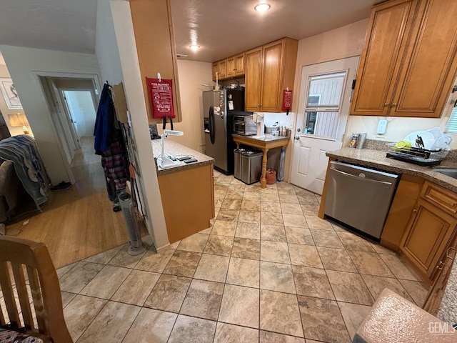 kitchen with stainless steel appliances and brown cabinetry