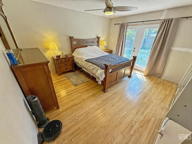 bedroom featuring ceiling fan, a textured ceiling, access to exterior, french doors, and light wood-style flooring