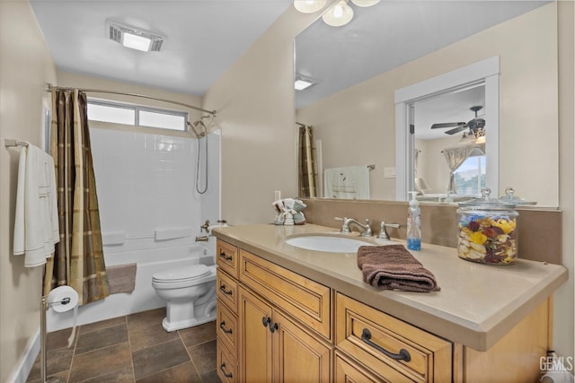 bathroom featuring toilet, plenty of natural light, vanity, and visible vents