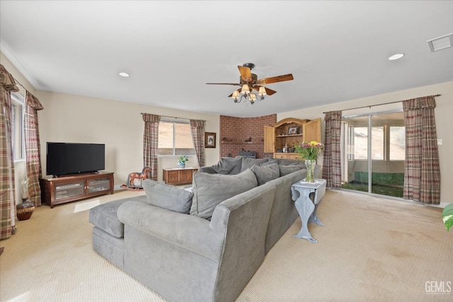 living room with a ceiling fan, recessed lighting, visible vents, and carpet flooring