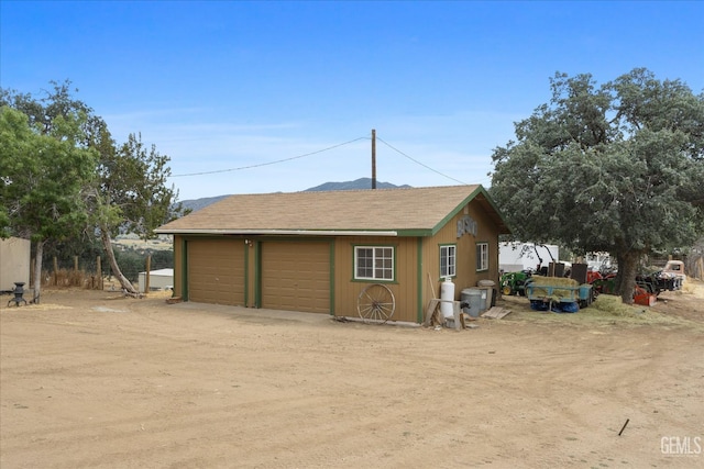 exterior space with a garage and an outdoor structure