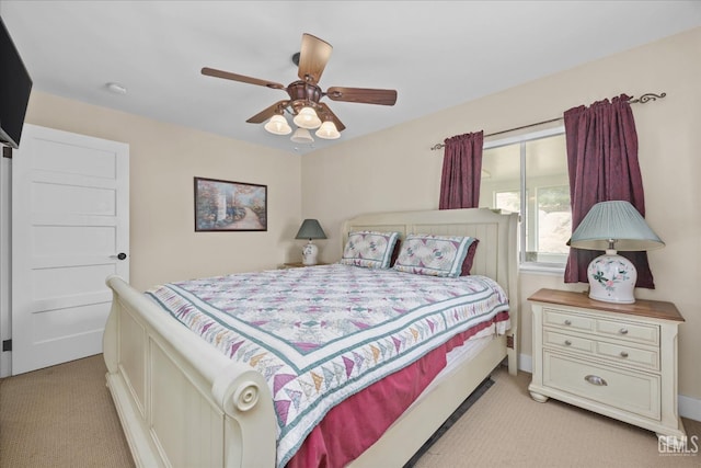 bedroom featuring a ceiling fan and light colored carpet