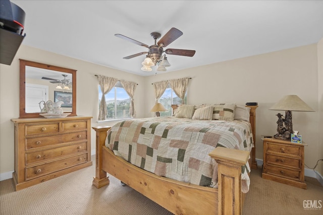 bedroom with light carpet, ceiling fan, and baseboards