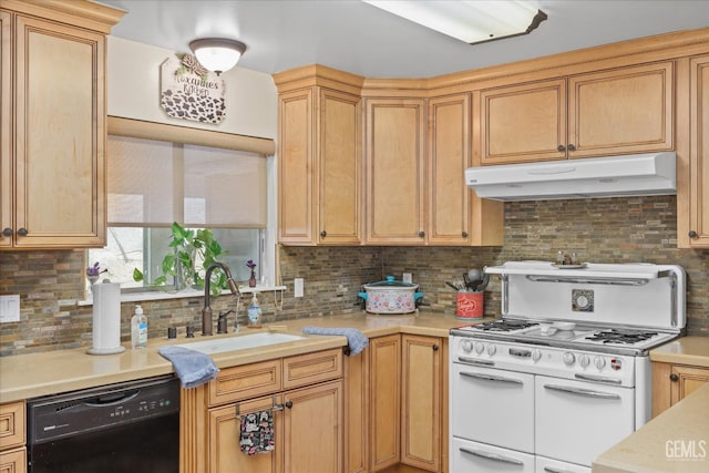 kitchen featuring light countertops, a sink, double oven range, dishwasher, and under cabinet range hood