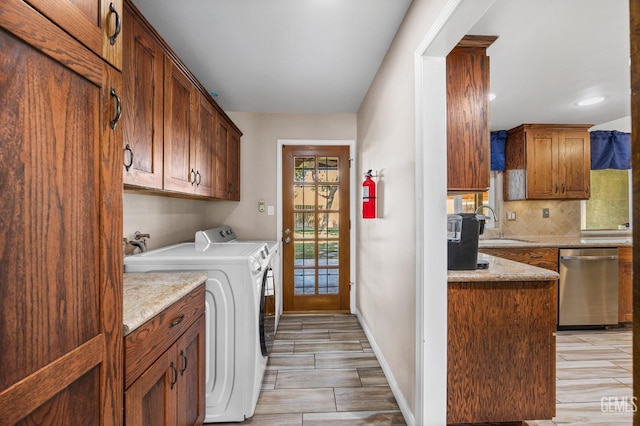 4512 Orrick Ct, Bakersfield, CA 93308 - laundry room featuring washing machine and clothes dryer, cabinet space, light wood-type flooring, and recessed lighting