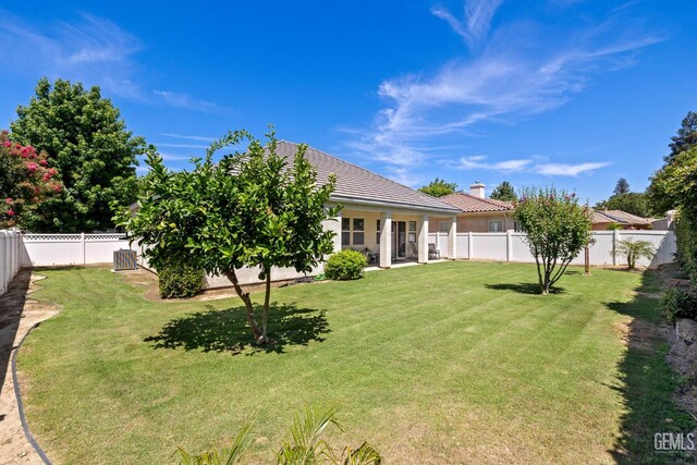 11901 Kimelford Dr, Bakersfield, CA 93312 - rear view of house featuring a fenced backyard, a chimney, and a tile roof