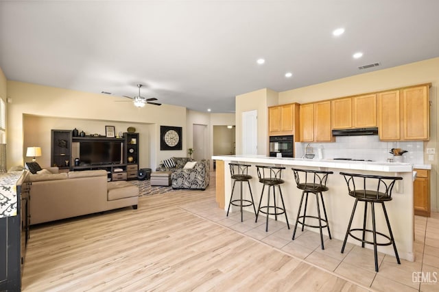 11901 Kimelford Dr, Bakersfield, CA 93312 - kitchen featuring oven, light brown cabinets, white gas stovetop, under cabinet range hood, and recessed lighting