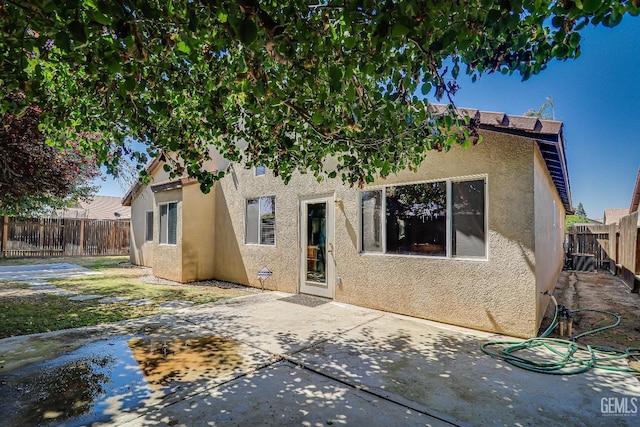 10126 Pyramid Peak Dr, Bakersfield, CA 93311 - rear view of property featuring stucco siding, a patio area, and a fenced backyard