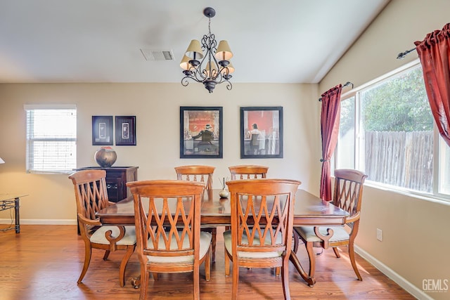 10126 Pyramid Peak Dr, Bakersfield, CA 93311 - dining space with wood finished floors and a chandelier