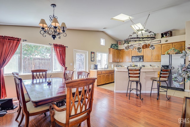 10126 Pyramid Peak Dr, Bakersfield, CA 93311 - dining area featuring plenty of natural light, a chandelier, light wood-style floors, and high vaulted ceiling