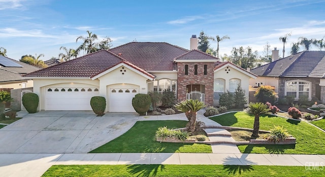 mediterranean / spanish-style home featuring a front yard and a garage