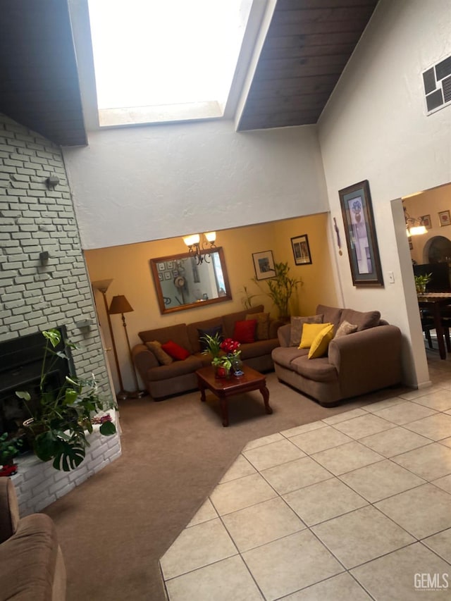 tiled living room with a chandelier, a towering ceiling, and a brick fireplace